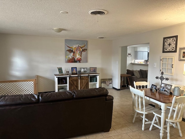 living room with light tile patterned flooring and a textured ceiling