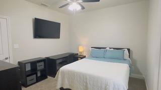 bedroom with ceiling fan and baseboards