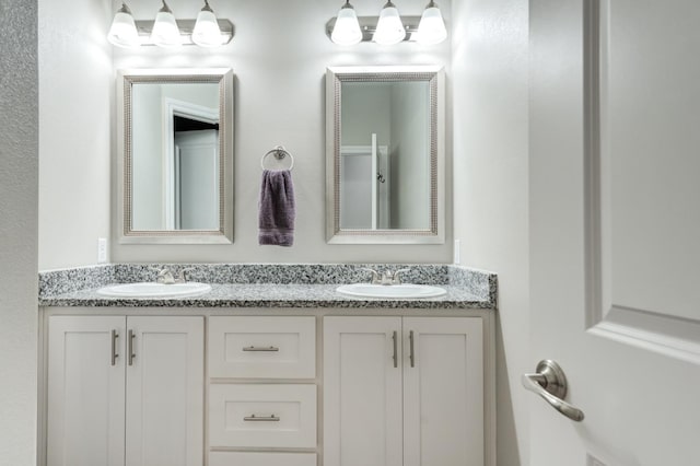bathroom with double vanity and a sink