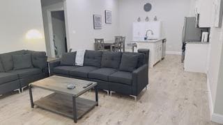 living area featuring baseboards and light wood-type flooring