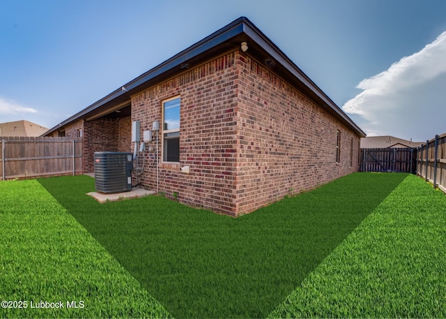 view of side of home with central AC unit and brick siding