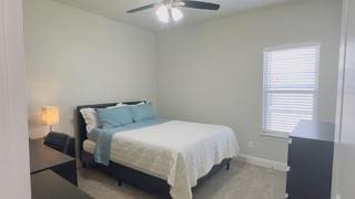 bedroom featuring baseboards and a ceiling fan