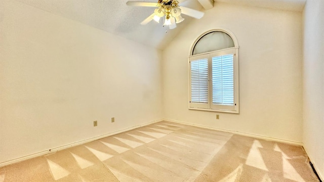 carpeted empty room with ceiling fan and lofted ceiling