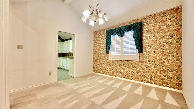 carpeted spare room featuring a chandelier and vaulted ceiling