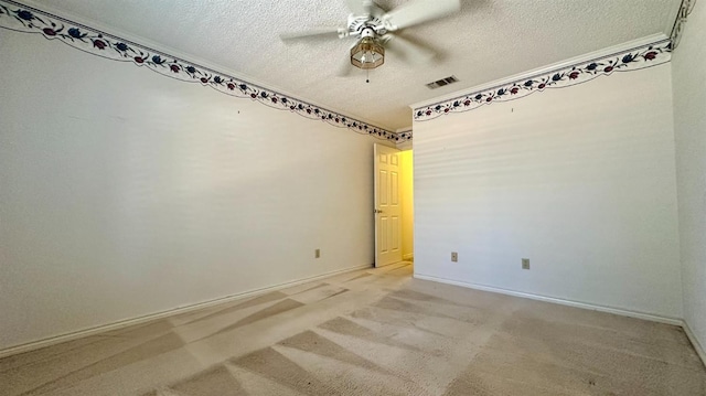 spare room with ceiling fan, carpet, and a textured ceiling