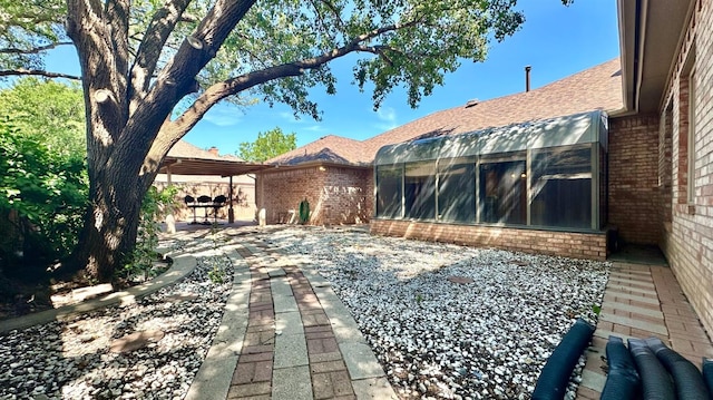 rear view of house with a patio and a sunroom