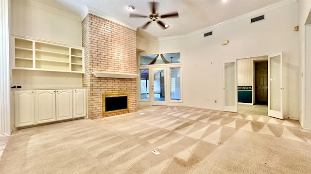 unfurnished living room with a fireplace, a high ceiling, ornamental molding, light colored carpet, and ceiling fan