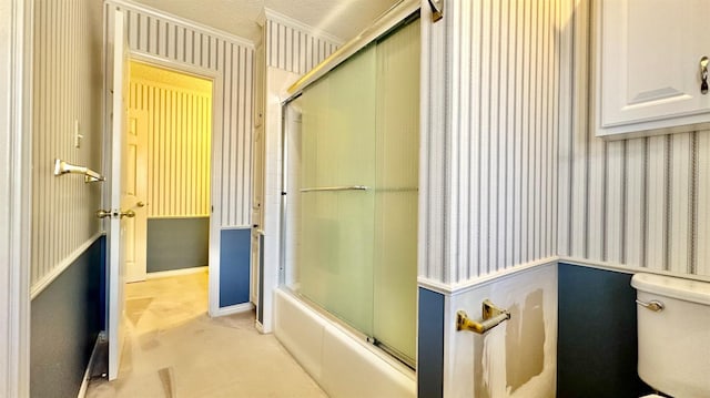 bathroom featuring shower / bath combination with glass door and toilet