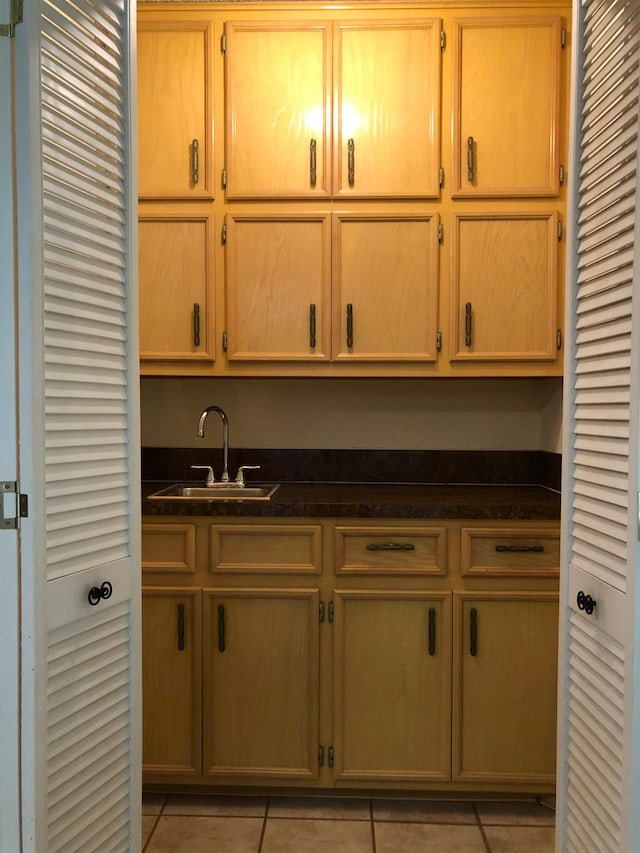 3423 94th St, Lubbock, TX 79423 - kitchen with a sink, light tile patterned flooring, and dark countertops