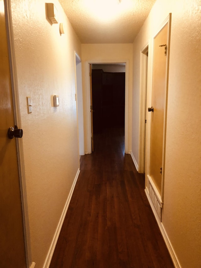 3423 94th St, Lubbock, TX 79423 - corridor with dark wood-type flooring and baseboards
