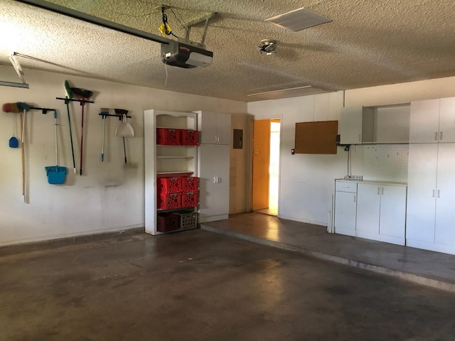 3423 94th St, Lubbock, TX 79423 - garage featuring a garage door opener and baseboards