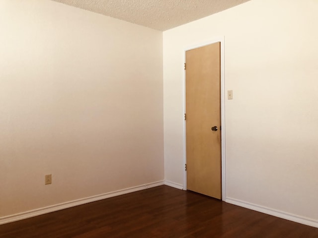 3423 94th St, Lubbock, TX 79423 - unfurnished room with dark wood-style floors, a textured ceiling, and baseboards