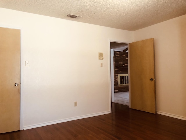 3423 94th St, Lubbock, TX 79423 - spare room featuring wood finished floors, a textured ceiling, and baseboards