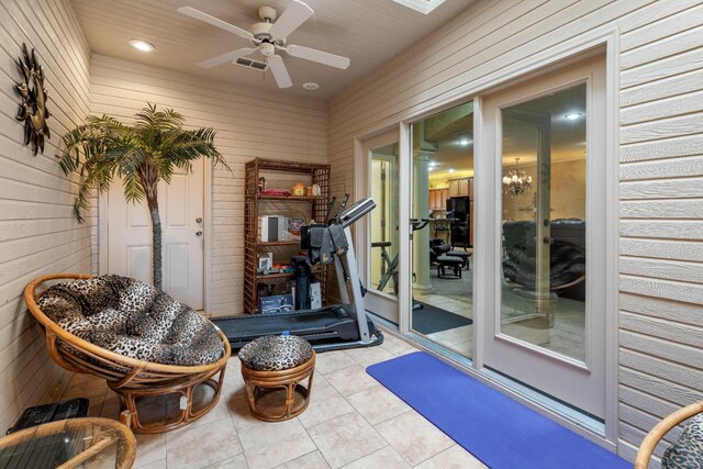 interior space featuring light tile patterned floors and ceiling fan