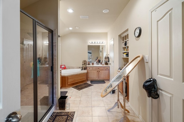 bathroom with tile patterned flooring, shower with separate bathtub, vanity, and built in features