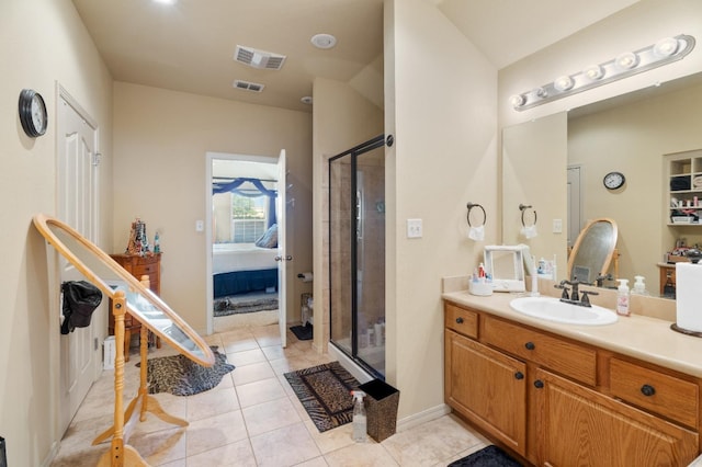 bathroom featuring vanity, tile patterned floors, and a shower with shower door