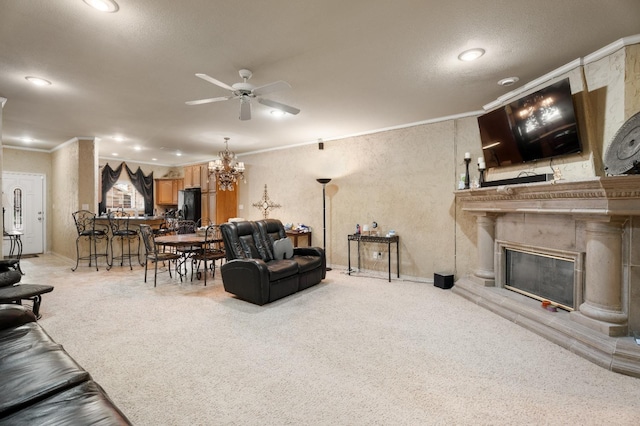 carpeted living room with ceiling fan, ornamental molding, and a high end fireplace