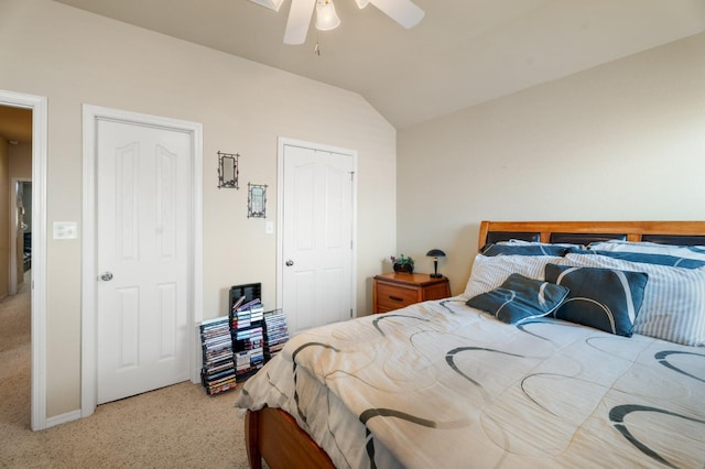 bedroom featuring vaulted ceiling, ceiling fan, and carpet flooring