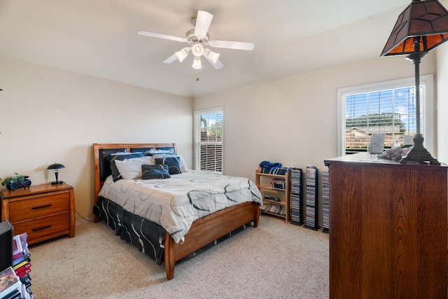 carpeted bedroom with multiple windows and ceiling fan