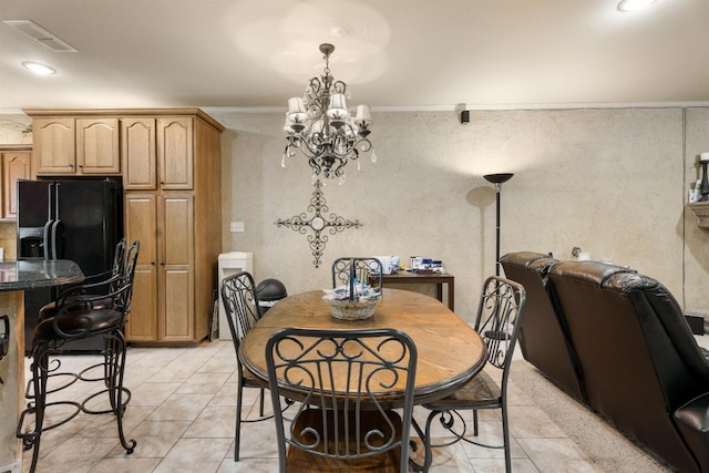 dining area with ornamental molding, light tile patterned floors, and an inviting chandelier