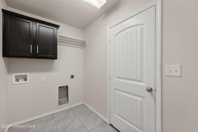10303 Valencia Ave, Lubbock, TX 79424 - laundry area with electric dryer hookup, washer hookup, baseboards, cabinet space, and light tile patterned floors
