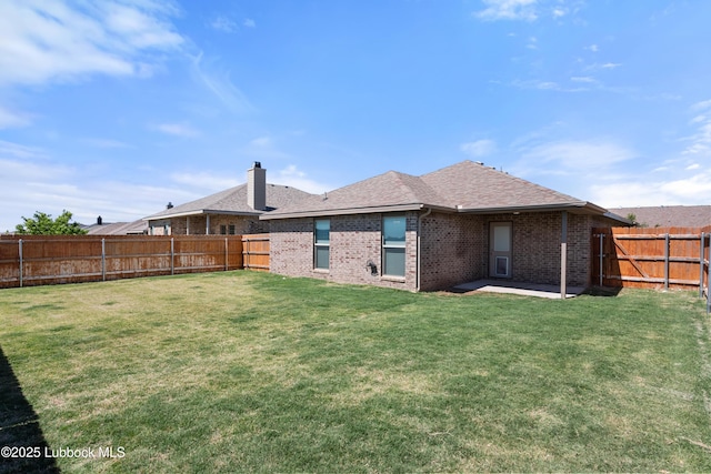 10303 Valencia Ave, Lubbock, TX 79424 - back of house featuring brick siding, a patio area, a shingled roof, and a chimney
