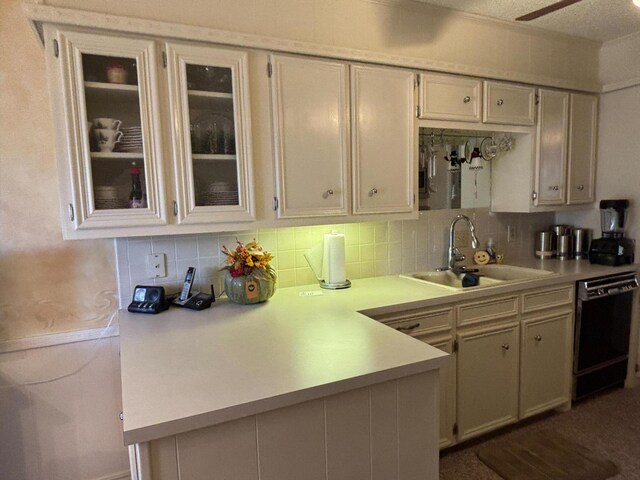 3004 80th St, Lubbock, TX 79423 - kitchen featuring black dishwasher, a sink, light countertops, and decorative backsplash