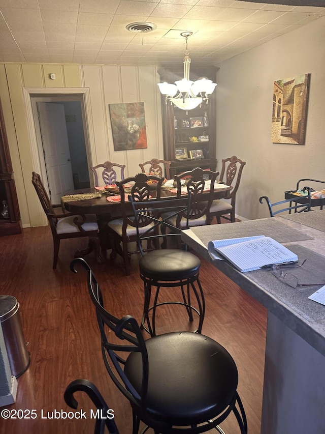 501 77th St, Lubbock, TX 79404 - dining area featuring a chandelier and wood finished floors