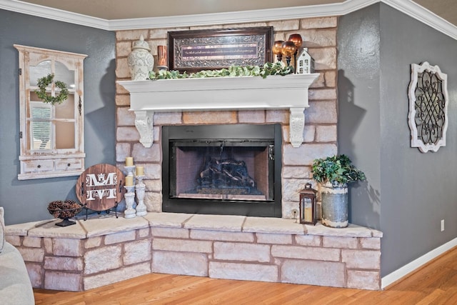 interior details featuring hardwood / wood-style flooring, ornamental molding, and a stone fireplace