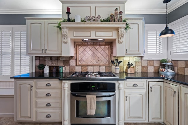 kitchen featuring ornamental molding, stainless steel appliances, decorative light fixtures, and cream cabinets