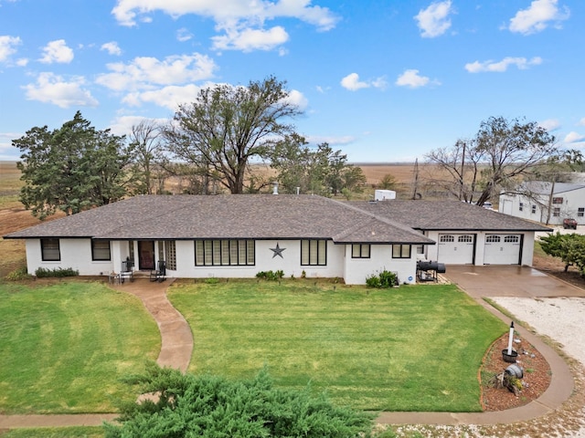 ranch-style house featuring a garage and a front lawn