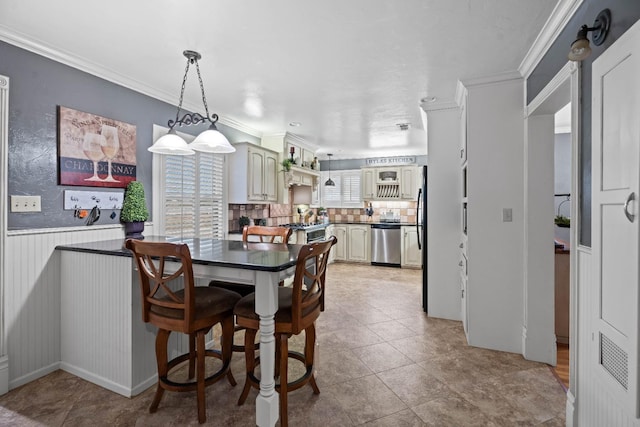 dining room featuring ornamental molding and light tile patterned floors