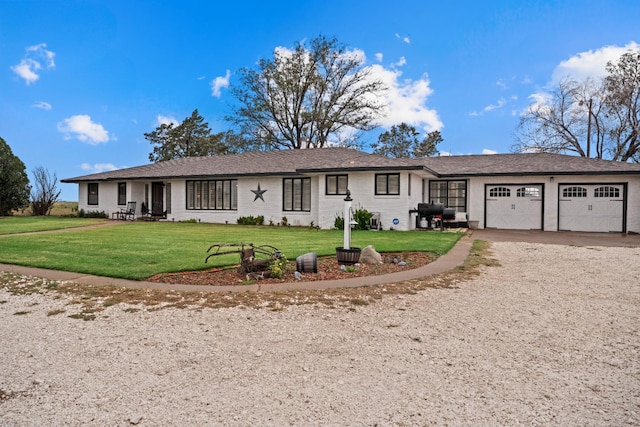 ranch-style house featuring a garage and a front yard