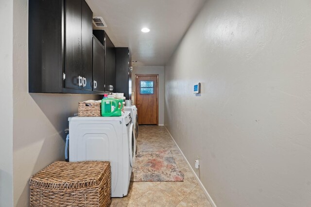 laundry area featuring cabinets and washing machine and clothes dryer