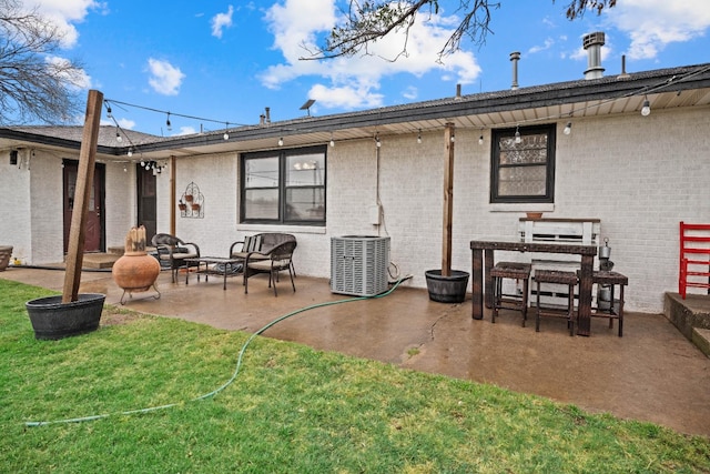 rear view of property featuring a yard, a patio area, and central air condition unit