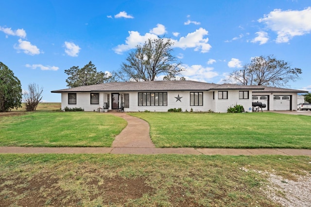 single story home with a garage and a front yard