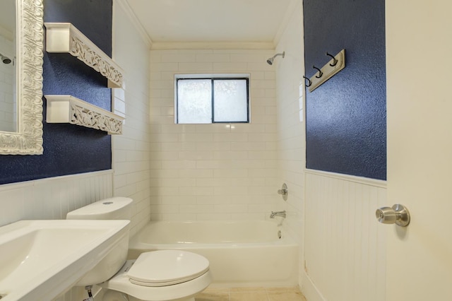 bathroom with tile patterned floors, ornamental molding, toilet, and tiled shower / bath