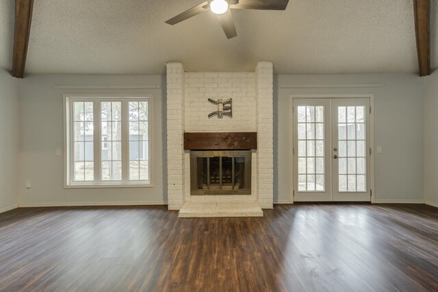 unfurnished living room featuring french doors, plenty of natural light, and a textured ceiling