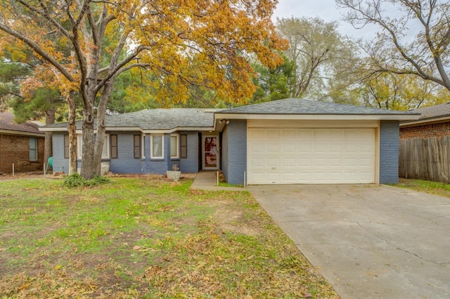 ranch-style house with a garage and a front lawn