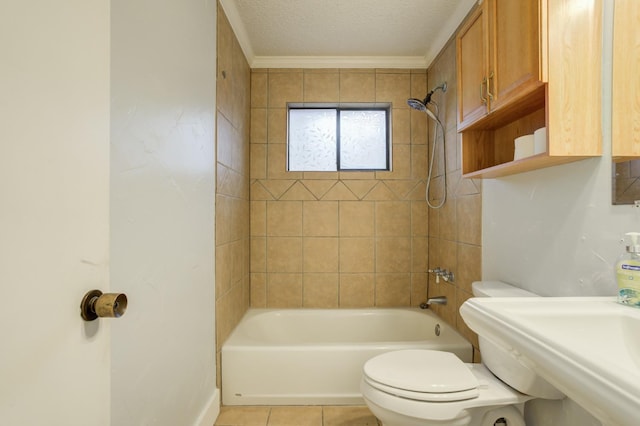 full bathroom with sink, tiled shower / bath combo, toilet, tile patterned floors, and a textured ceiling