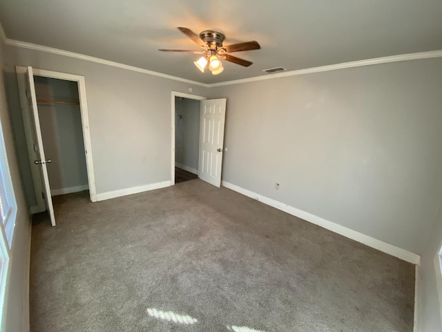 unfurnished bedroom with crown molding, a closet, ceiling fan, and carpet