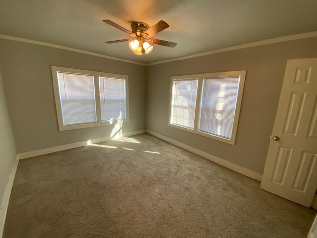 empty room with ceiling fan, ornamental molding, and light carpet