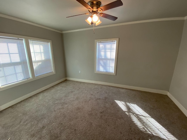 empty room with ceiling fan, a healthy amount of sunlight, ornamental molding, and carpet floors