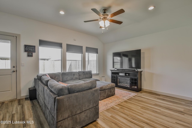 7406 9th St, Lubbock, TX 79416 - living room with healthy amount of natural light, wood finished floors, ceiling fan, vaulted ceiling, and recessed lighting