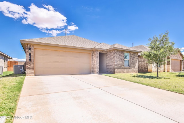 7406 9th St, Lubbock, TX 79416 - view of front of home with brick siding, concrete driveway, an attached garage, and central AC unit