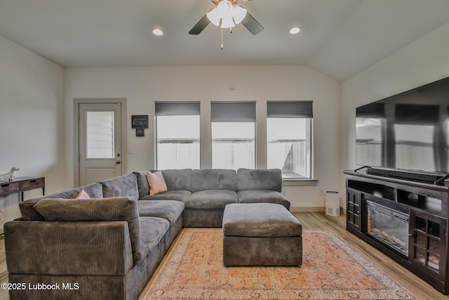 7406 9th St, Lubbock, TX 79416 - living room featuring healthy amount of natural light, light wood-style flooring, a ceiling fan, lofted ceiling, and baseboards