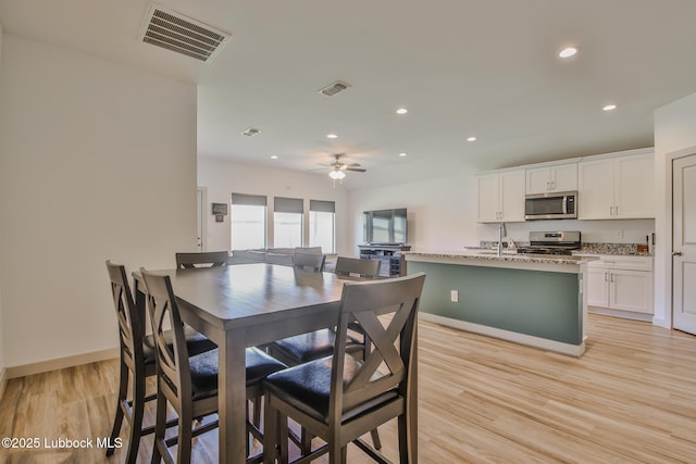 7406 9th St, Lubbock, TX 79416 - dining area featuring recessed lighting, a ceiling fan, light wood-style floors, and baseboards