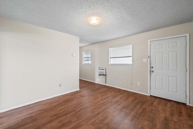 entryway featuring an AC wall unit, a textured ceiling, and dark hardwood / wood-style flooring