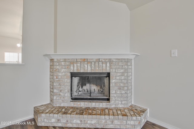 6801 36th St, Lubbock, TX 79407 - detailed view of baseboards, wood finished floors, and a fireplace