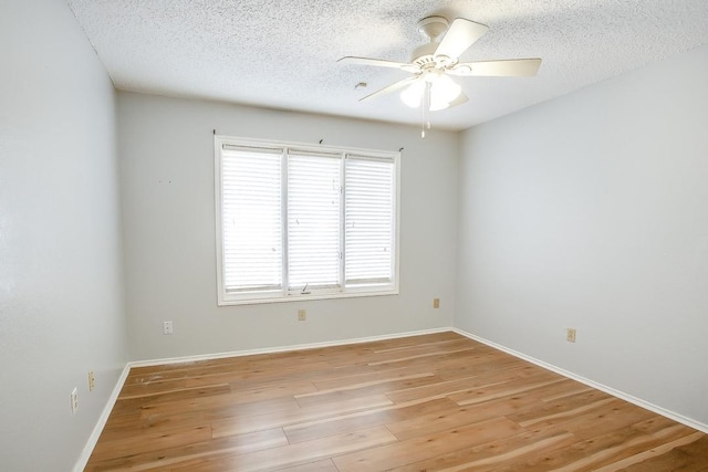 spare room featuring ceiling fan, a textured ceiling, and light wood-type flooring